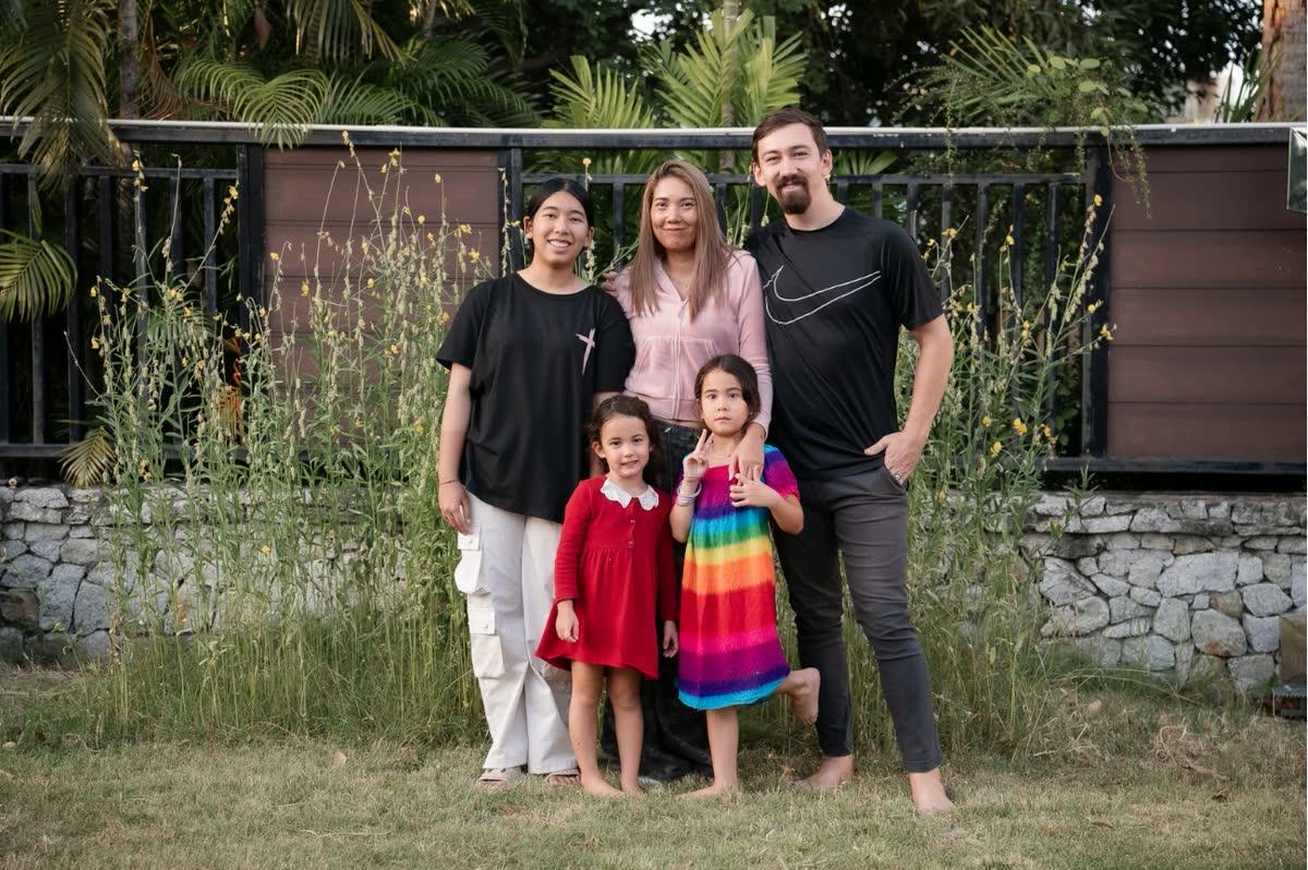 Ewan, Dao and their three daughters in the garden at The Landing