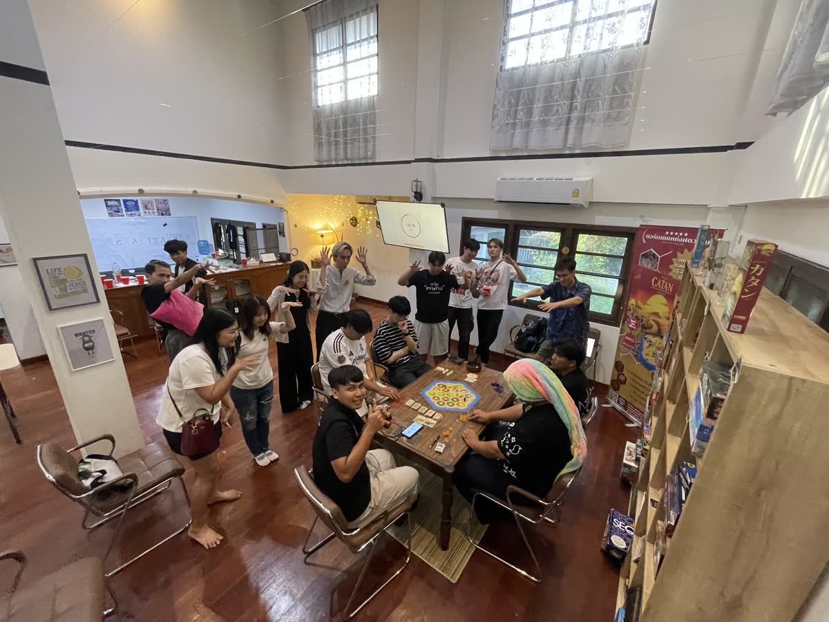 Students around the board game tables at Games Night